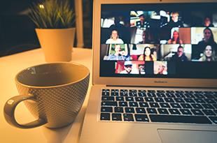 A zoom meeting on  a laptop screen.