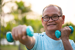 A man uses hand weights.