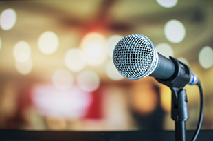 A microphone sits in a microphone stand.