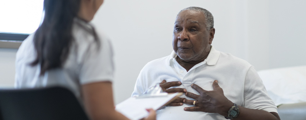 A man meets with a health care provider for a medical exam.